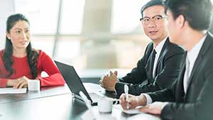 three people at a business meeting three people at a business meeting