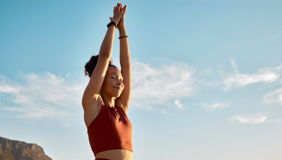 Black woman, yoga pray hands and meditation wellness on beach. H