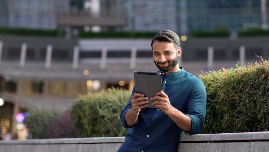 Professional indian business man using digital tablet in night c