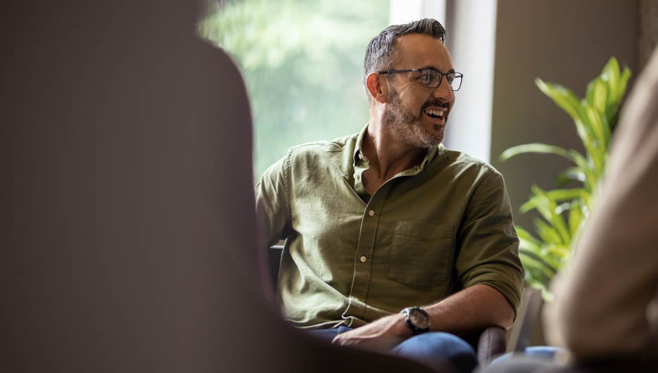 Mature businessman laughing during a meeting with office colleag
